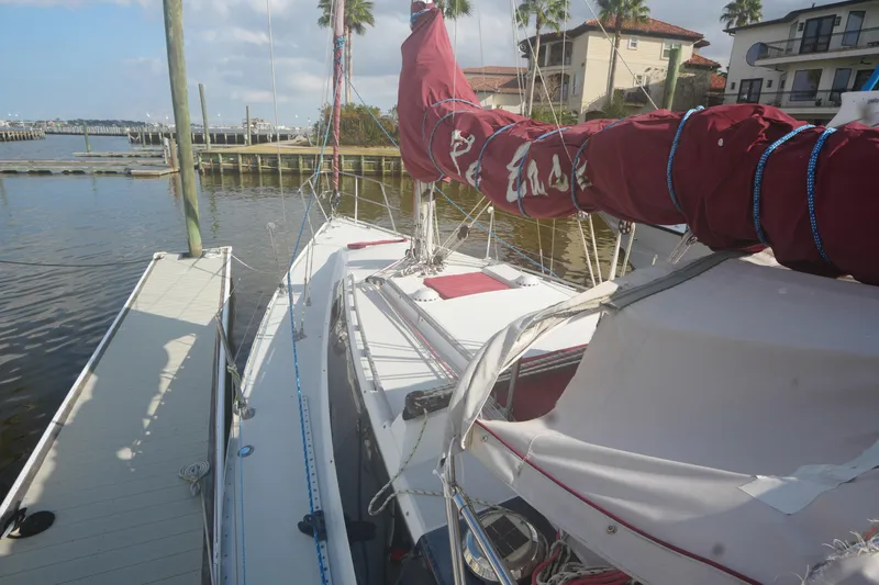 Slide: The Image of 1987 O'Day 322 sailboat docked at marina with red sail cover. - 6
