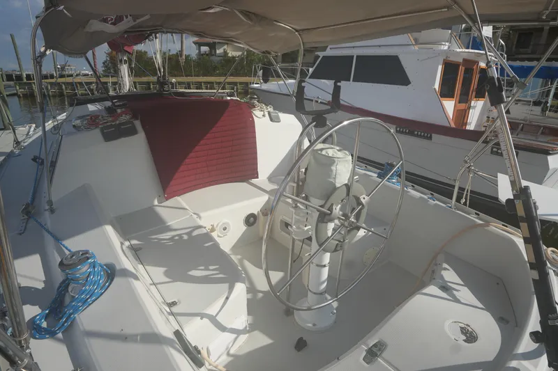 Slide: The Image of Cockpit of a 1987 O'Day 322 sailboat with steering wheel and seating area. - 7