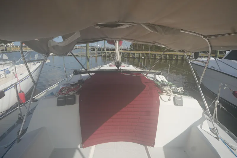 Slide: The Image of 1987 O'Day 322 sailboat cockpit with canopy and marina view. - 9