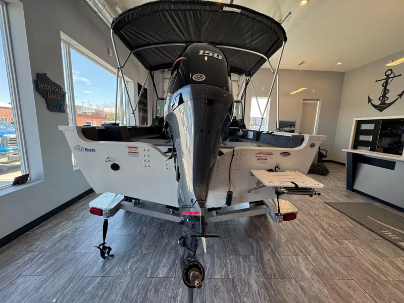 Slide: The Image of 2025 G3 AV17SF boat with 150 HP motor displayed indoors. - 12