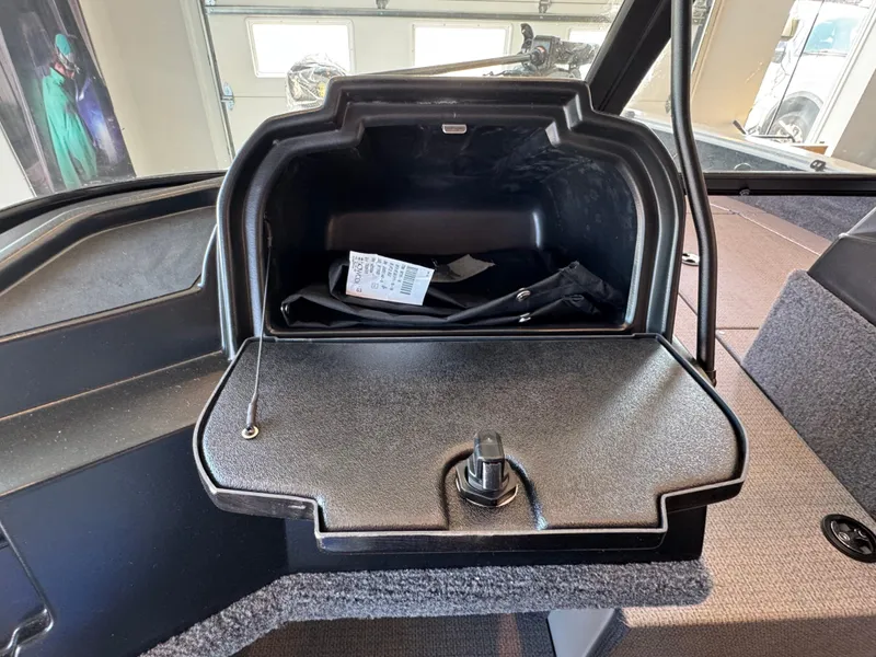 Slide: The Image of Open glove compartment in a 2025 G3 AV17SF boat, showing interior storage space. - 18