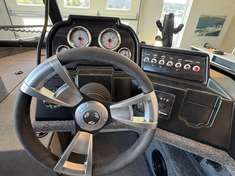 Slide: The Image of Steering wheel and dashboard of 2025 G3 AV17SF boat, featuring gauges and control panel. - 20