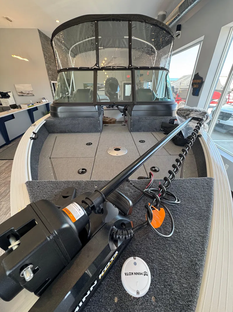 Slide: The Image of 2025 G3 AV17SF boat interior with Minn Kota trolling motor, spacious deck, and protective canopy. - 6