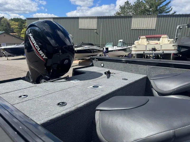 Slide: The Image of 2022 Tracker V-18 Targa boat with Mercury engine, parked outdoors under blue sky. - 11
