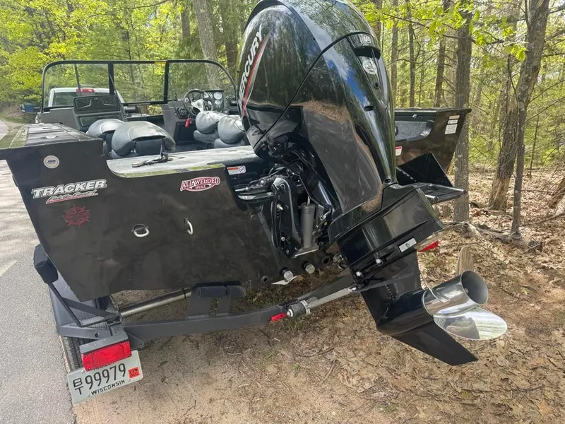Slide: The Image of 2022 Tracker V-18 Targa boat with Mercury outboard motor in a wooded area. - 3