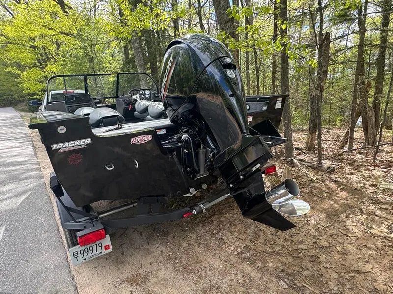Slide: The Image of 2022 Tracker V-18 Targa boat with Mercury engine parked in a wooded area. - 4