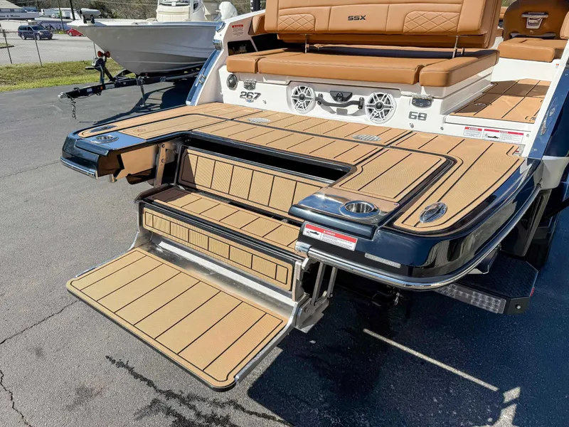 Slide: The Image of 2025 Chaparral 267 SSX boat with teak swim platform and seating area. - 10