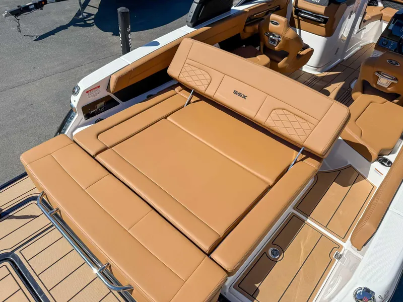 Slide: The Image of 2025 Chaparral 267 SSX boat interior with tan leather seating and modern design. - 11