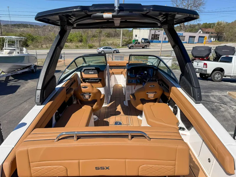 Slide: The Image of 2025 Chaparral 267 SSX boat interior with tan seating and modern dashboard. - 12