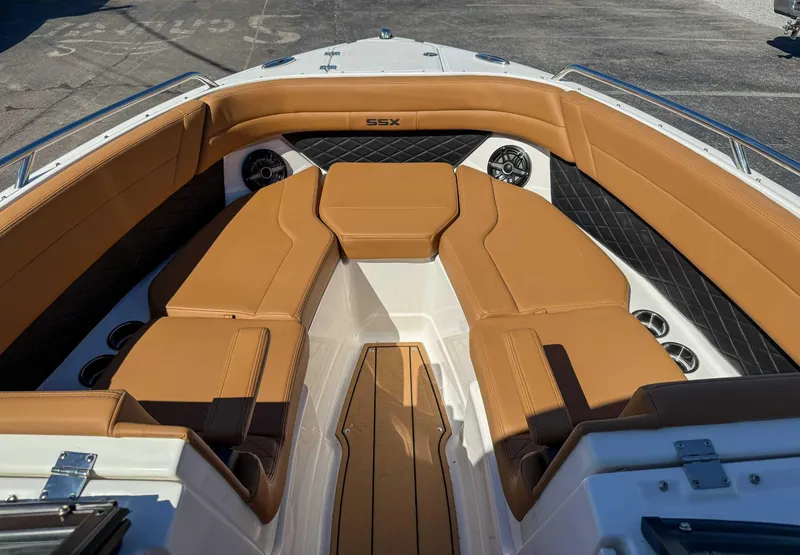 Slide: The Image of 2025 Chaparral 267 SSX boat interior with tan leather seating and cup holders. - 13