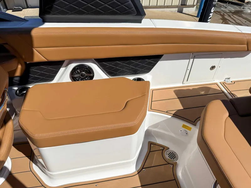Slide: The Image of 2025 Chaparral 267 SSX boat interior with tan seating and black accents. - 18