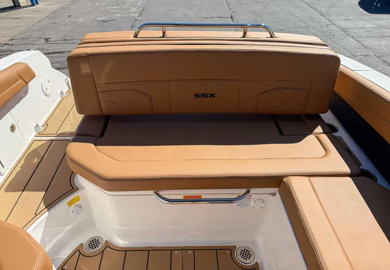 Slide: The Image of 2025 Chaparral 267 SSX boat interior with tan leather seating and sleek design. - 19
