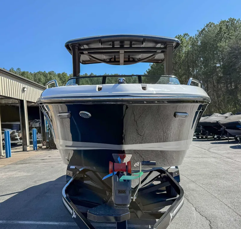 Slide: The Image of 2025 Chaparral 267 SSX boat on trailer, front view, outdoors. - 4