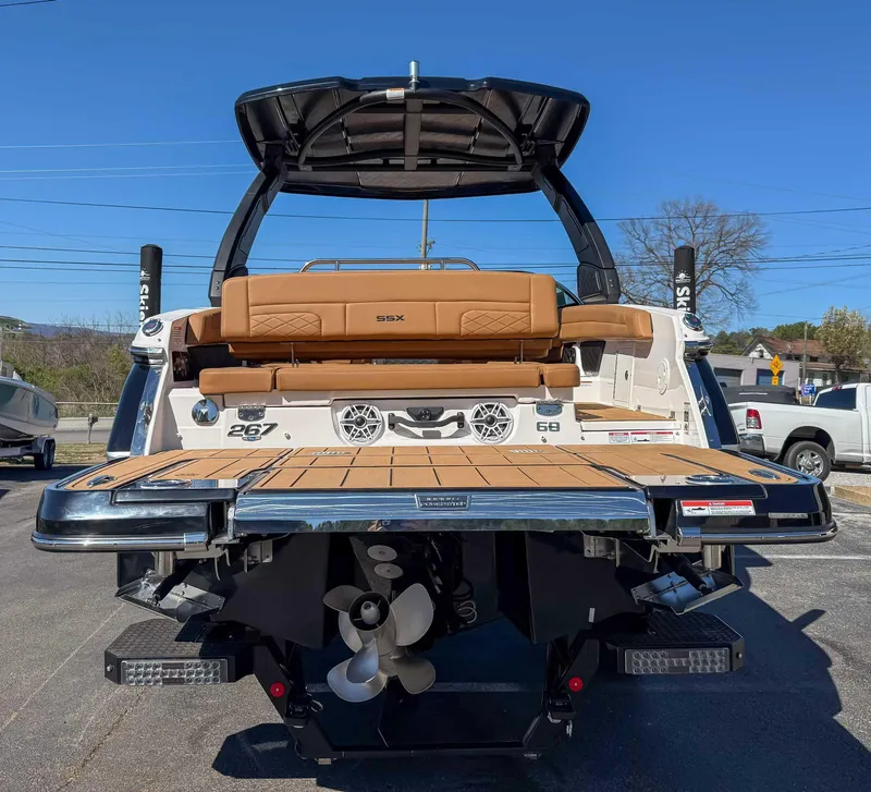 Slide: The Image of 2025 Chaparral 267 SSX boat, rear view with swim platform and seating. - 9