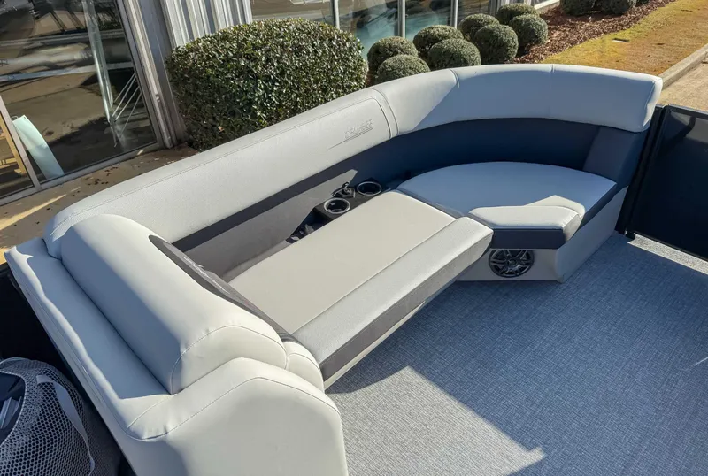 Slide: The Image of 2025 Harris Cruiser 230 CWDH boat interior with plush seating and cup holders. - 11