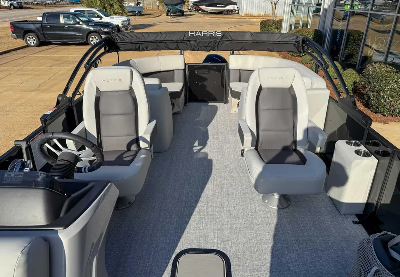 Slide: The Image of 2025 Harris Cruiser 230 CWDH pontoon boat interior with gray seating and steering wheel. - 14