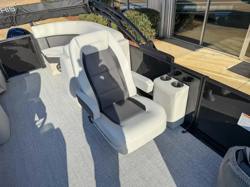 Slide: The Image of 2025 Harris Cruiser 230 CWDH boat interior with plush seating and cup holders. - 15
