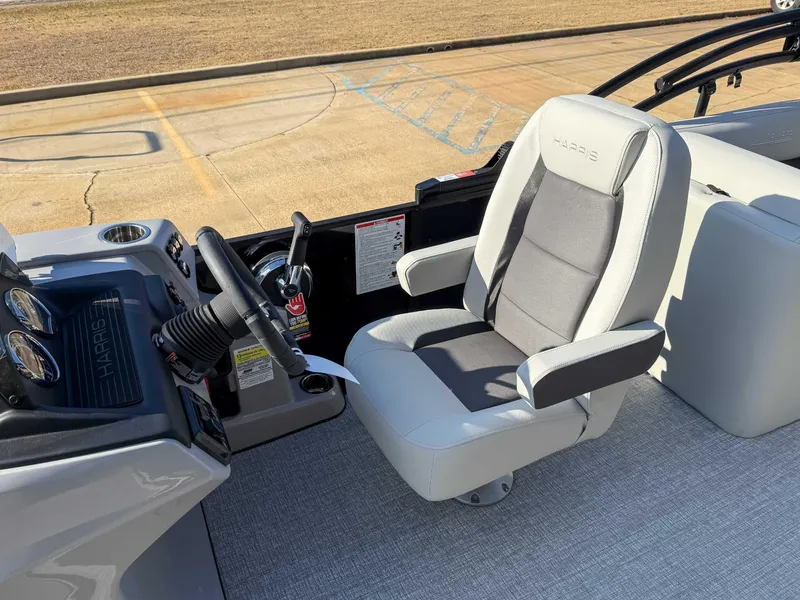 Slide: The Image of Captain's seat and helm of 2025 Harris Cruiser 230 CWDH boat. - 16