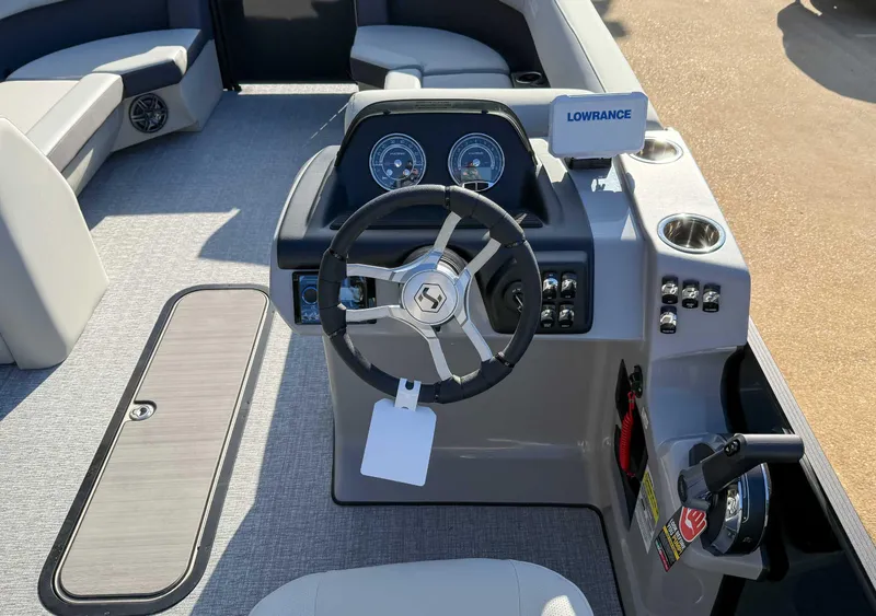 Slide: The Image of 2025 Harris Cruiser 230 CWDH boat dashboard with steering wheel and controls. - 17