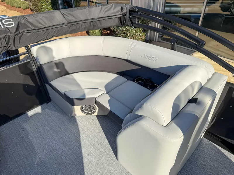 Slide: The Image of 2025 Harris Cruiser 230 CWDH boat interior with plush seating and cup holders. - 19