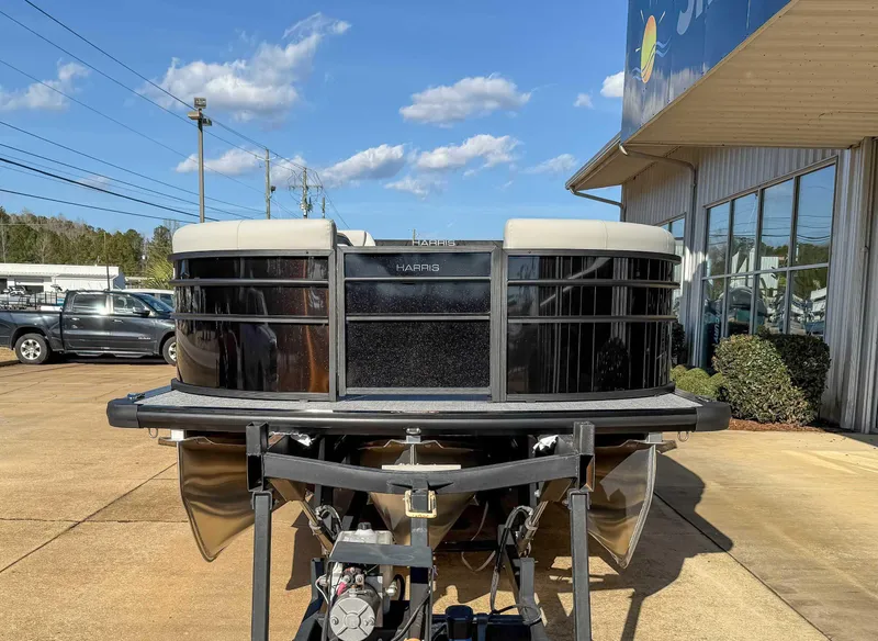 Slide: The Image of 2025 Harris Cruiser 230 CWDH pontoon boat displayed outdoors on a sunny day. - 3