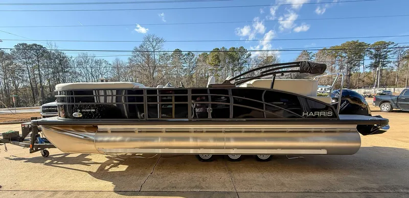 Slide: The Image of 2025 Harris Cruiser 230 CWDH pontoon boat on a sunny day, side view. - 5