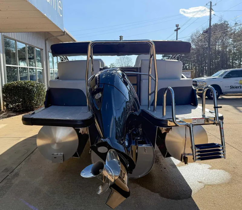 Slide: The Image of 2025 Harris Cruiser 230 CWDH pontoon boat with powerful outboard motor, docked outdoors. - 8