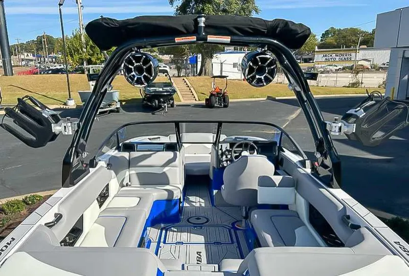 Slide: The Image of 2024 Moomba Mojo boat interior with seating, speakers, and steering wheel. - 11