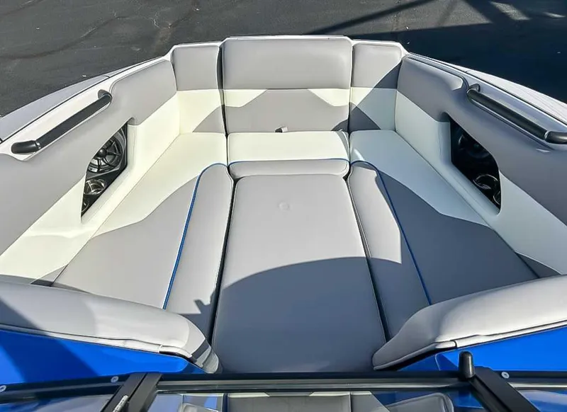 Slide: The Image of 2024 Moomba Mojo boat interior with gray and white cushioned seating. - 14