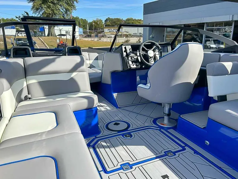 Slide: The Image of 2024 Moomba Mojo boat interior with modern seating and sleek dashboard design. - 19
