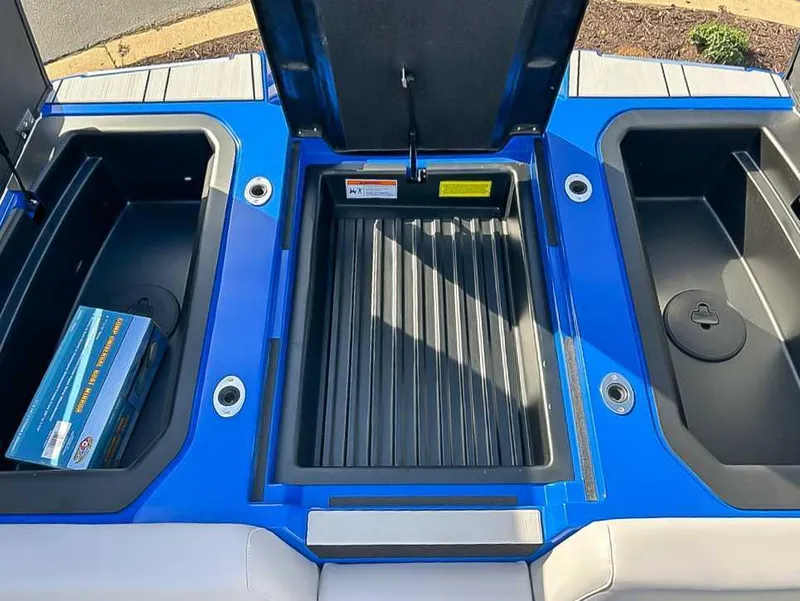 Slide: The Image of 2024 Moomba Mojo boat storage compartments with blue and black design. - 20