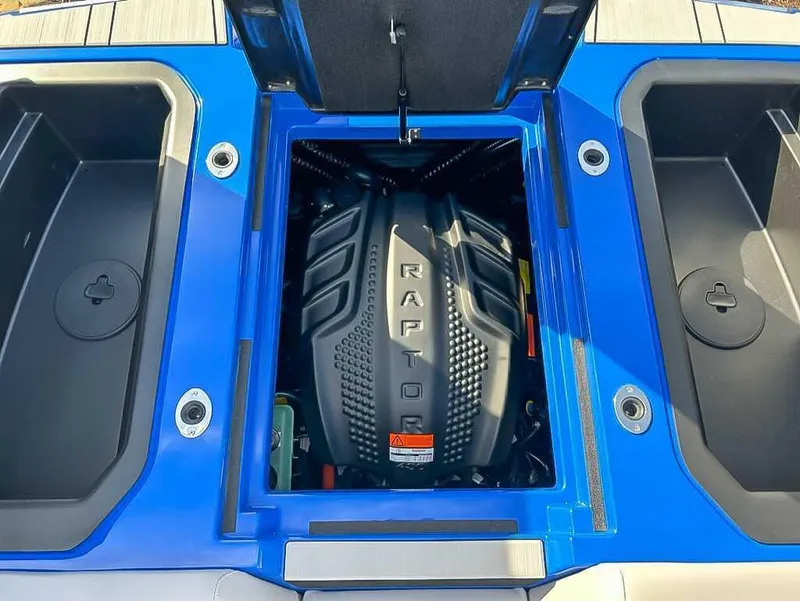 Slide: The Image of 2024 Moomba Mojo boat engine compartment with Raptor engine, blue and black design. - 21