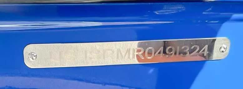 Slide: The Image of 2024 Moomba Mojo boat identification plate on blue surface. - 23