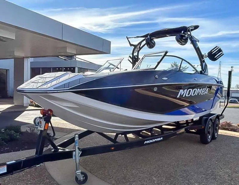 Slide: The Image of 2024 Moomba Mojo boat on trailer, displayed outdoors under clear sky. - 3