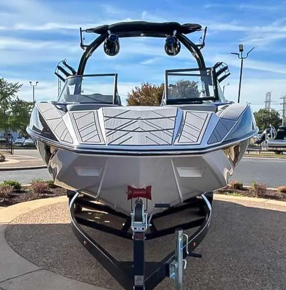 Slide: The Image of 2024 Moomba Mojo boat on trailer, front view, under clear blue sky. - 4