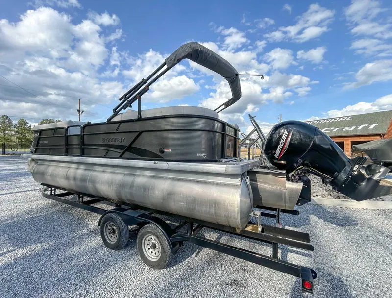 Slide: The Image of 2022 Godfrey Sweetwater pontoon boat with Mercury outboard motor on a trailer. - 4