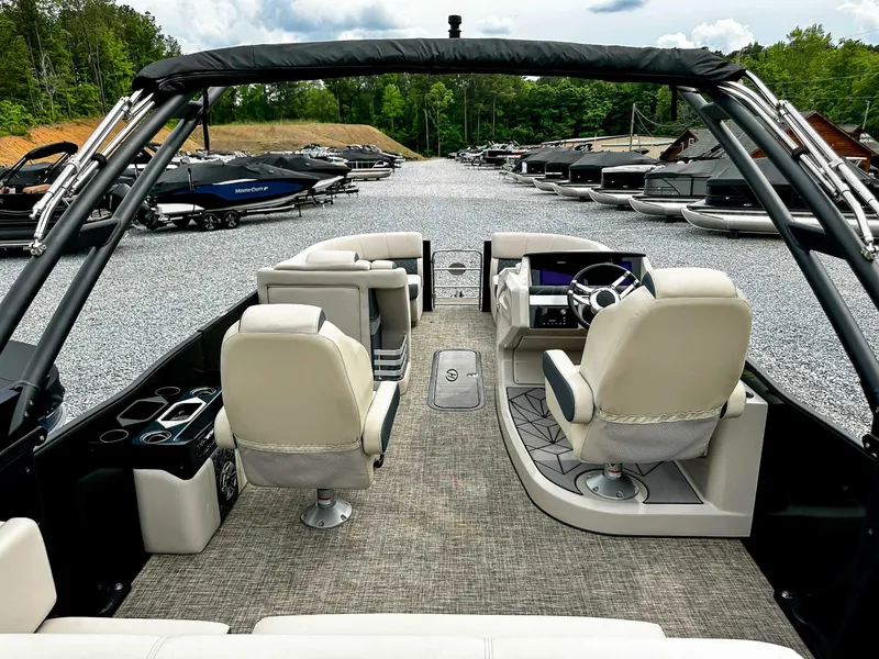 Slide: The Image of 2023 Harris Grand Mariner 230 pontoon boat interior with plush seating and modern dashboard. - 10