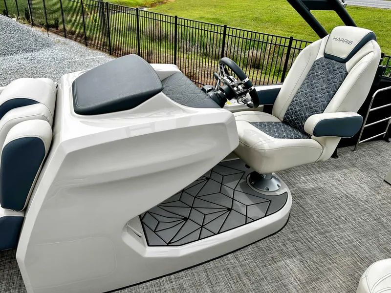 Slide: The Image of 2023 Harris Grand Mariner 230 boat interior with luxurious seating and modern steering console. - 17