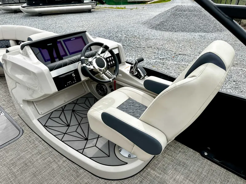Slide: The Image of 2023 Harris Grand Mariner 230 helm with modern steering and control panel. - 18
