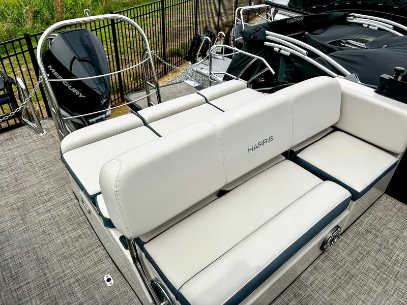 Slide: The Image of 2023 Harris Grand Mariner 230 boat with white seating and Mercury engine. - 21