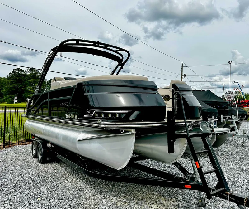 Slide: The Image of 2023 Harris Grand Mariner 230 pontoon boat on trailer, displayed outdoors. - 4