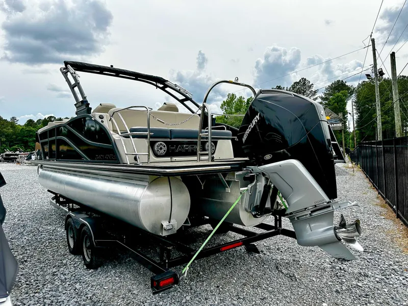 Slide: The Image of 2023 Harris Grand Mariner 230 pontoon boat on trailer, featuring a powerful Mercury outboard motor. - 7