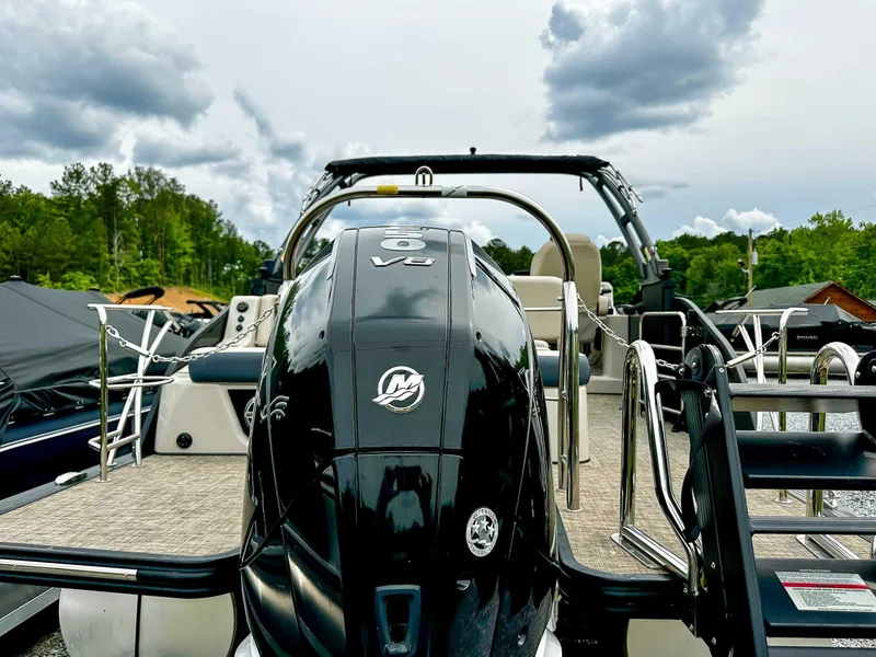 Slide: The Image of 2023 Harris Grand Mariner 230 boat with powerful V8 engine, docked under cloudy skies. - 8