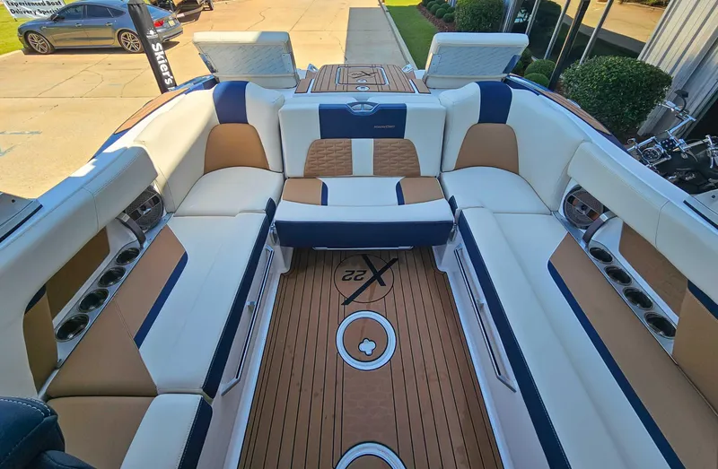 Slide: The Image of 2021 MasterCraft X22 boat interior with luxurious seating and teak flooring. - 16
