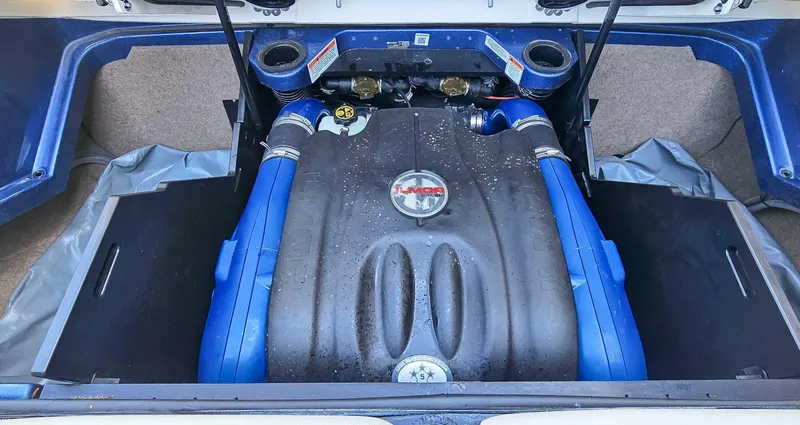 Slide: The Image of 2021 MasterCraft X22 engine compartment with Ilmor engine, featuring blue accents and clean design. - 18