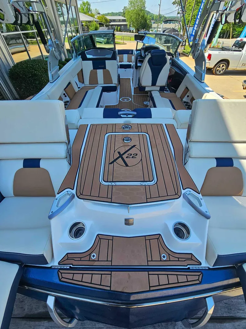 Slide: The Image of 2021 MasterCraft X22 boat interior with luxurious seating and teak flooring. - 9