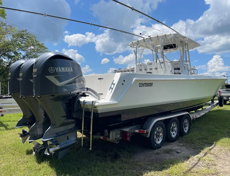 Slide: The Image of 2009 Contender 39 Tournament boat with Yamaha engines on a trailer, under a blue sky. - 1