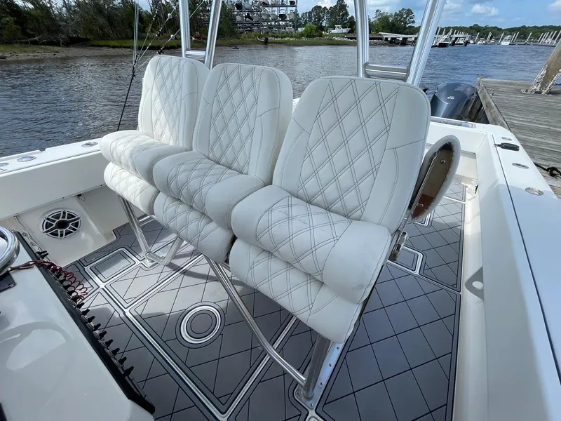 Slide: The Image of Luxurious seating on a 2009 Contender 39 Tournament boat, featuring diamond-stitched upholstery. - 10