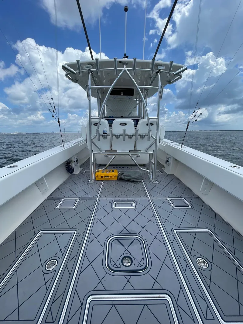 Slide: The Image of 2009 Contender 39 Tournament boat deck with fishing rods, under a blue sky. - 12