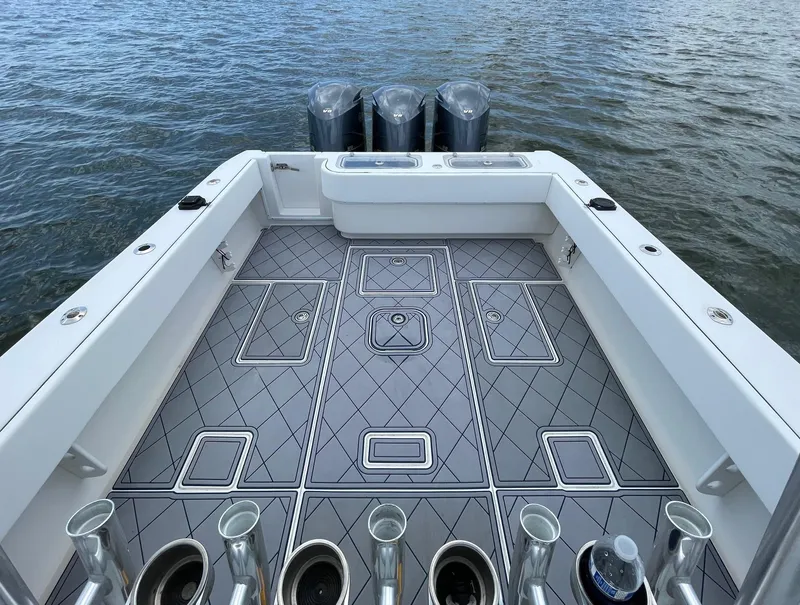 Slide: The Image of 2009 Contender 39 Tournament boat deck with triple outboard motors on the water. - 13